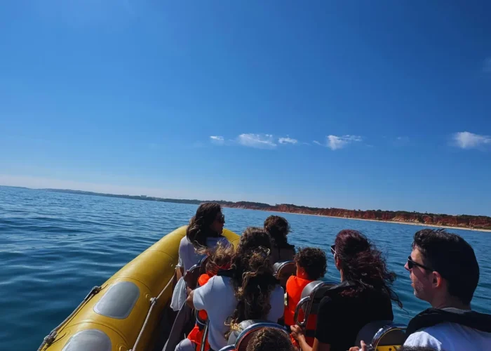 Sunny boat tour along the Algarve Tourists on a yellow boat enjoying a sunny day at sea along the Algarve coast