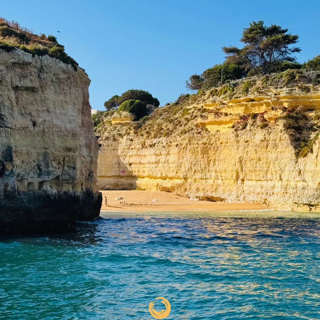 "Secluded Algarve beach surrounded by golden cliffs and turquoise water