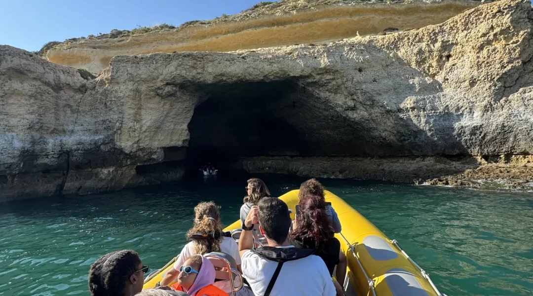 Otter Tours guests relaxing on the boat while cruising near the Algarve’s coastal rock formations