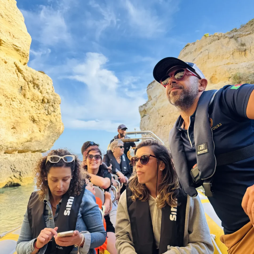 Otter Tours guests observing Algarve’s coastal cliffs from the boat during a guided sea cave tour