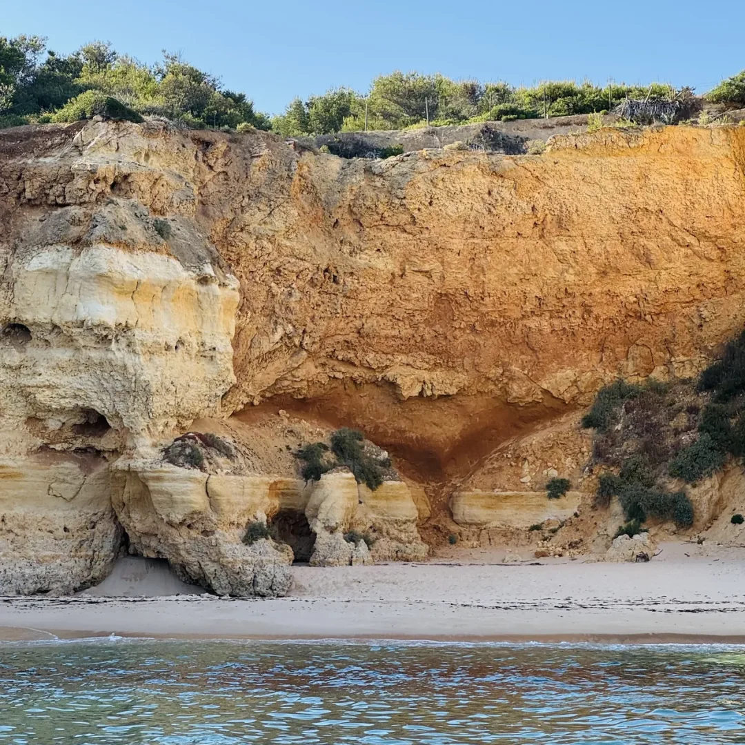 Otter Tours guests inside a sea cave, observing rock formations during a guided boat tour in the Algarve